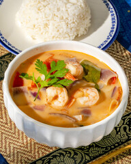 Creamy tom yum soup swirls with citrusy lemongrass, vibrant shrimp joyously dancing, perfect for Songkran festivities or Wokhei celebrations