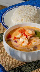 Steaming Tom Yum soup dances with shrimp and lemongrass, capturing the zest of Songkran festival and culinary zen