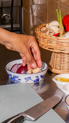 A Middle-Eastern female hand skillfully curates vibrant ingredients, echoing Eid al-Adha's culinary...
