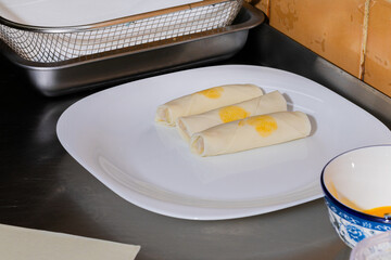 Delicate cheese-filled blintzes poised on porcelain, celebrating Maslenitsa and International...