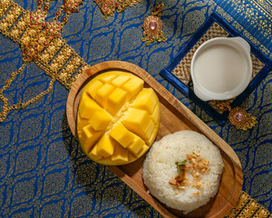 Silky coconut milk cascades over glistening mango and sticky rice tableau, evoking Songkran...