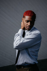 Portrait of a red-haired man looking down in an introspective state.