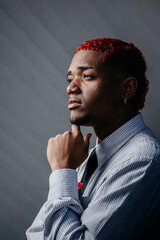 Reflective young Black man with red hair in profile
