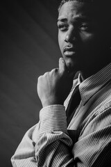 Thoughtful Black Man in Striped Shirt. Black and White Portrait