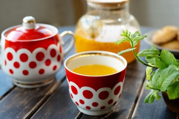 Cup of sea buckthorn tea on table. Tea party.