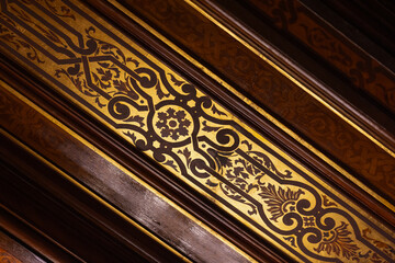 Detailed image showcasing an ornate golden and brown inlay pattern