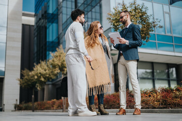 A group of people engaged in a professional discussion outdoors, showcasing teamwork and collaboration.