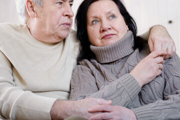 Senior couple hugging each other, kissing at home bedroom. Intimate Moment. Tender embrace between...