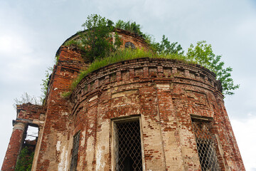 A crumbling historic red brick building. The church is in a dilapidated state.