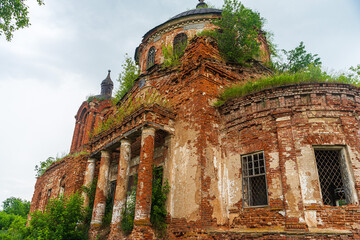 A crumbling historic red brick building. The church is in a dilapidated state.