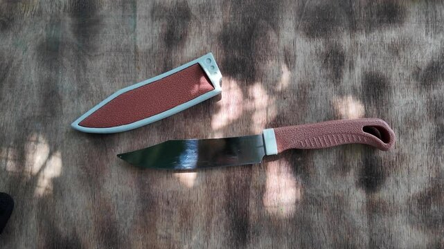 knife with brown handle. knife with sheath. brown vintage knife in hands. 4k video in high definition