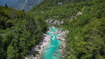 Picturesque panoramic view of scenic Soca river. Vibrant turquoise water, rocks, trees and idyllic mountain valley. Slovenia