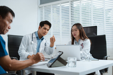 Healthcare team reviews patient info, medication, and health progress on charts. Collaborative care...