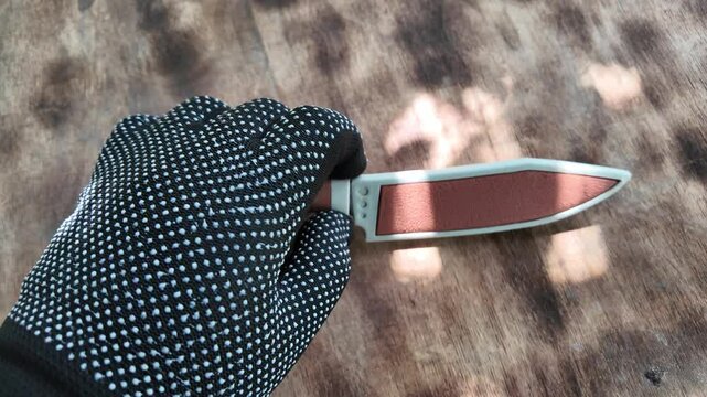 knife with brown handle. knife with sheath. brown vintage knife in hands. 4k video in high definition