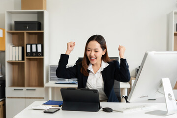 Overjoyed charming excited business woman worker using laptop working in office, feeling happy.