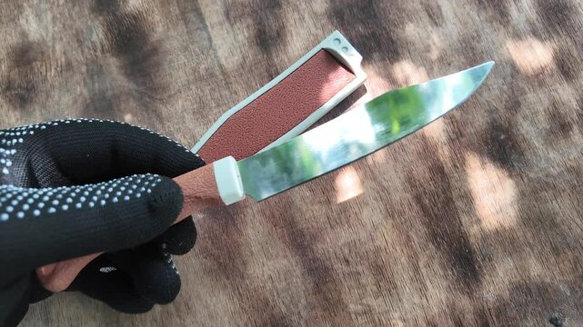 knife with brown handle. knife with sheath. brown vintage knife in hands. 4k video in high definition