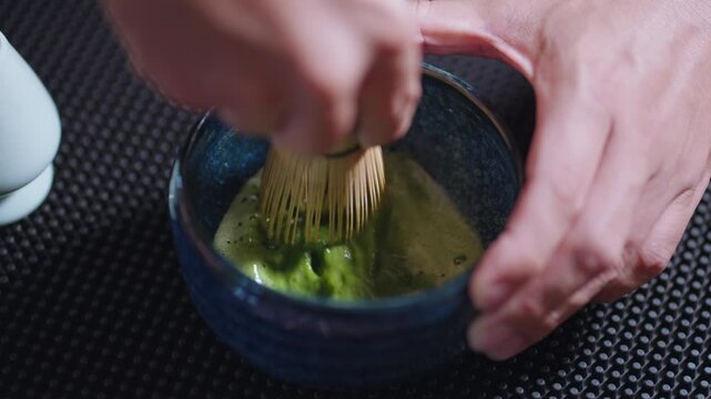 Preparing Matcha Tea Latte at home from measuring, whisking with a bamboo chasen, and pouring into a glass, capturing the soothing ritual of making this traditional Japanese drink.