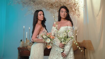 Candid shot of two beautifull female brides during their wedding ceremony indoor 
