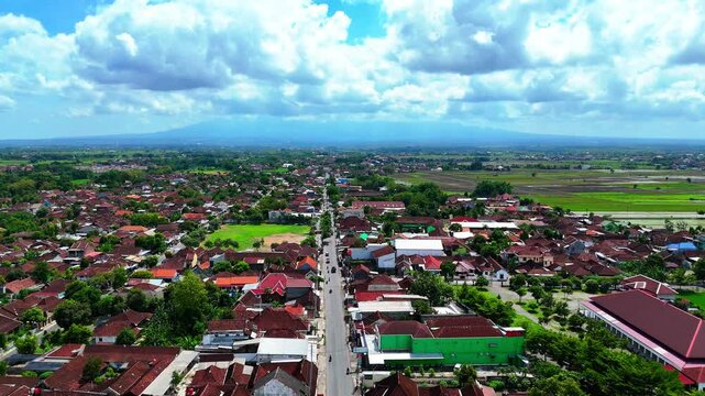 Overhead perspective revealing a village and a mountain