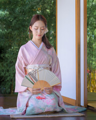 A pretty young Asian Japanese woman in a Traditional Yukata Dress. A young Asian girl wearing a...