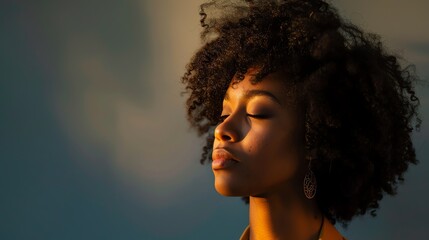 Thoughtful young woman with curly hair and closed eyes