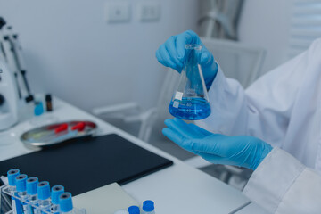 a female chemist is testing various liquid compounds in a lab, a scientist is doing research on the...