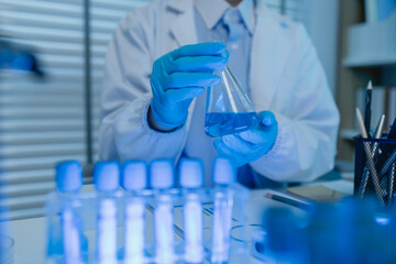 a female chemist is testing various liquid compounds in a lab, a scientist is doing research on the...