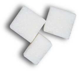 Three white sugar cubes arranged on a dark background.