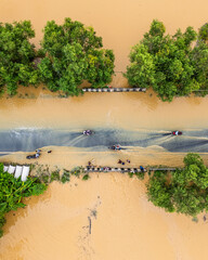 Overhead view of monsoon flood destruction in village with homes underwater.