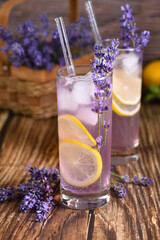  A glass of homemade lavender lemonade. Garnished with lemon wedges and lavender sprigs