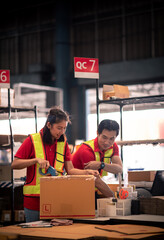 Factory worker,Shipping Team in Distribution Warehouse Packing Products for Delivery with Colleague...