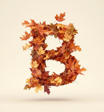 The letter "B" is made of falling autumn leaves