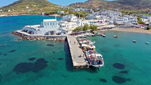 Fishing boats and white houses on the coast of Pollonia village, Milos, Greece
