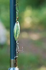 Close-up of fishing rod and spinners for fishing. Spinning rods for sport fishing. Vertical photo