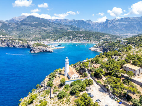 Port de Soller on Mallorca island with lighthouse from above aerial view holiday by the sea in Spain