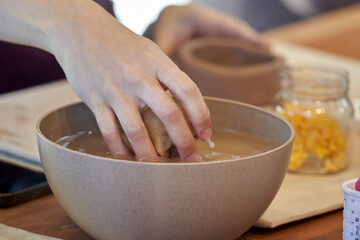Shape clay with hands