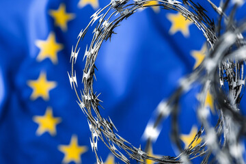 Barbed wire against a backdrop of the European Union flag Generative AI