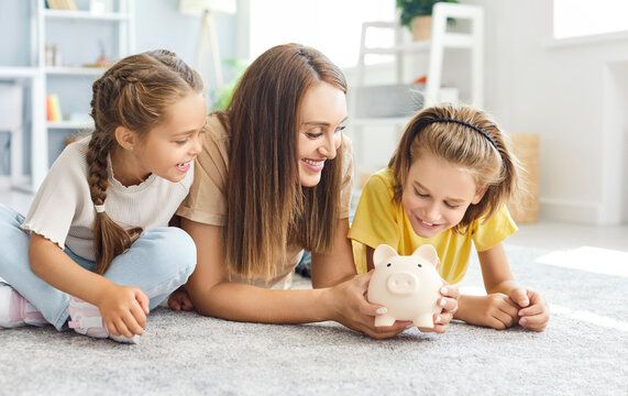 Happy family, kids and mother saving money together, playing with piggy bank, parent, children at home, teaching little son, daughter to invest money planning life, financial future, calculate savings