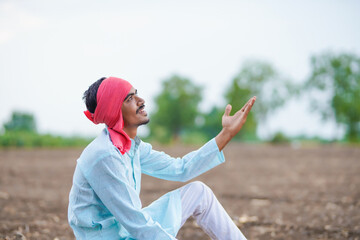 Indian farmer looking in sky and waiting for the rain