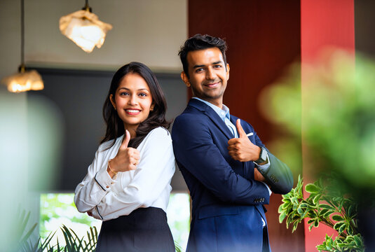 Posing with success and smiling confidently, Indian business professionals stand in office together - Powered by Adobe