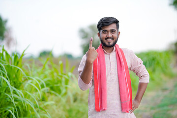 Young Indian farmer showing finger after voting