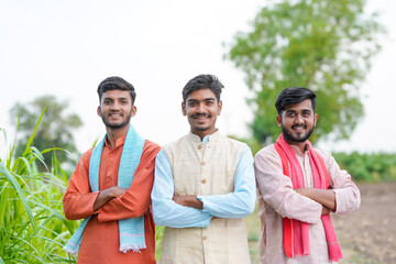 young indian farmer group standing together at agricultural field