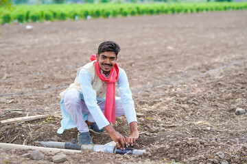 young indian farmer working in agricultural field