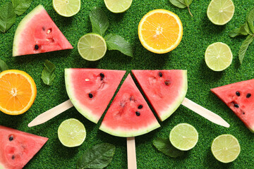 Ripe watermelon pieces, lime halves, oranges and mint. Summer fruit background. Flat lay....