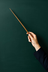 A dressed in a tailored navy blazer holds a smooth wooden pointer symbolizing guidance and clarity in communication