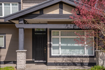 Two story stucco luxury house with nice spring blossom landscape in Vancouver, Canada, North...