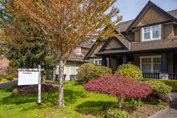 Two story stucco luxury house with nice spring blossom landscape in Vancouver, Canada, North...