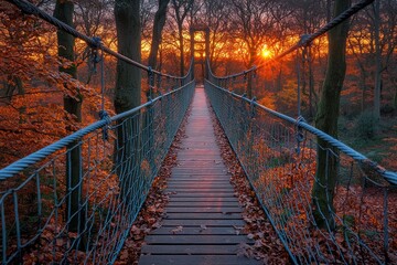 Wooden suspension bridge at sunset through autumn forest