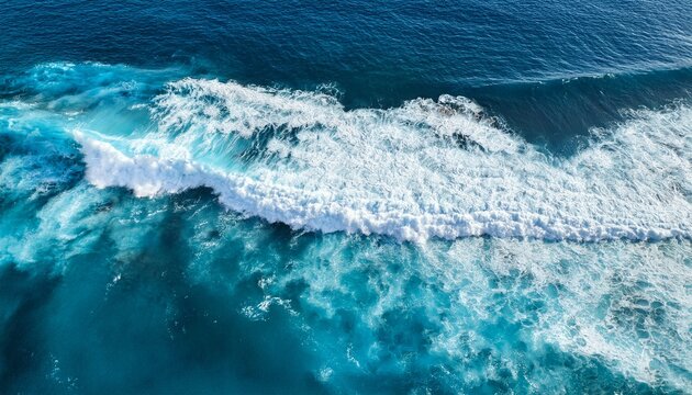 dynamic ocean waves crashing in turquoise blue aerial view of sea foam