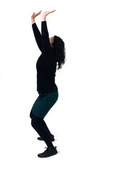 side view of a standingwoman holding or pushing something imaginary upwards.